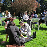 Conversation continues on sunny lawn of Stamford Court, University of Leicester